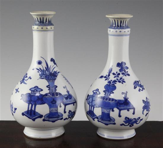 A pair of Chinese blue and white bottle vases, Kangxi period, 19.5cm, rims restored